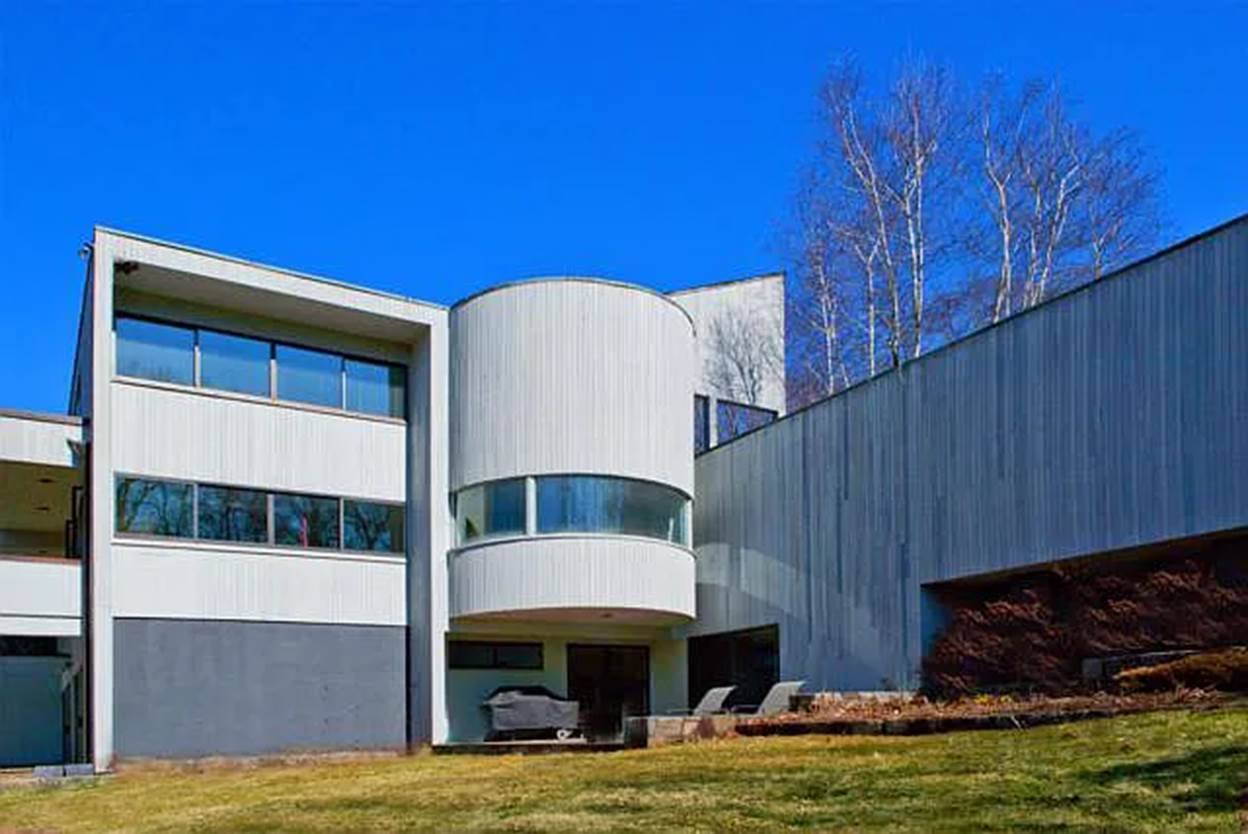 A building with a lawn and trees
