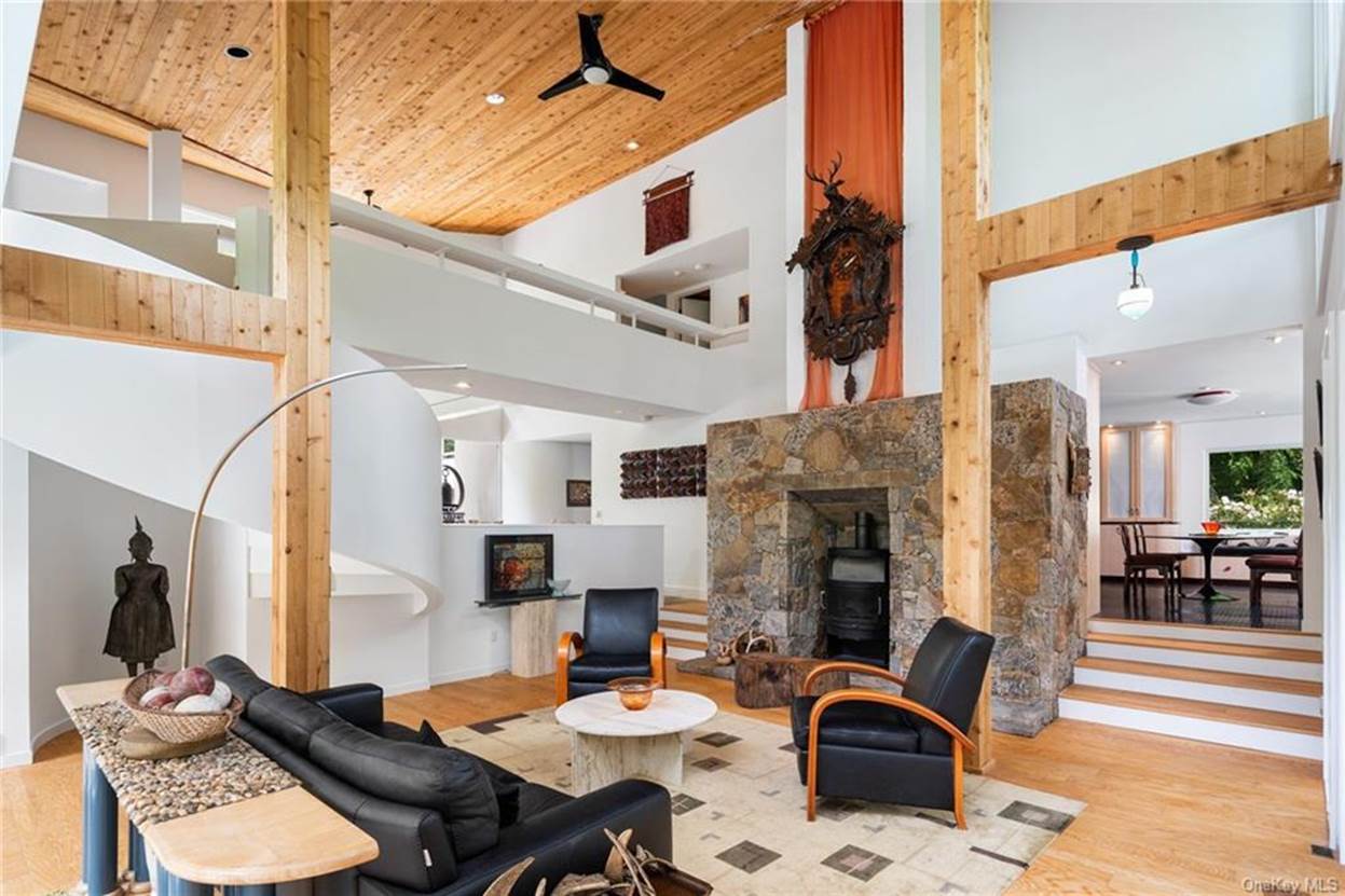 A living room with a fireplace and a large stone fireplace
