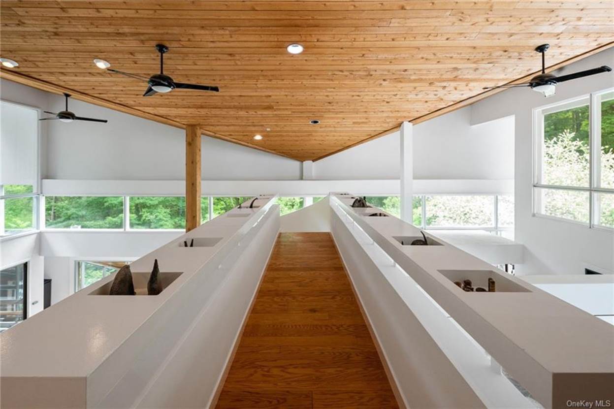 A long white staircase with wood ceiling
 with medium confidence