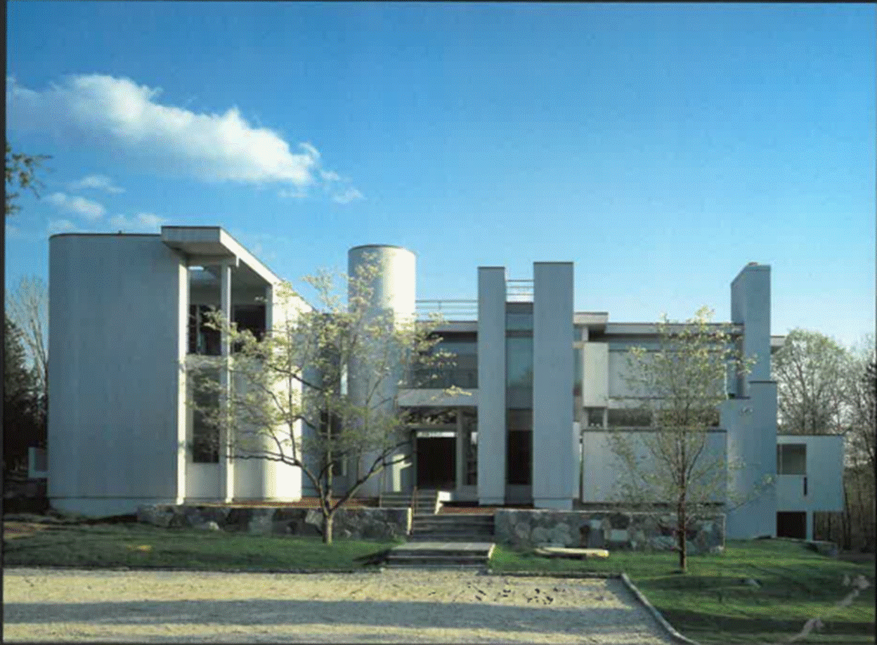 A white house with trees in front of it
