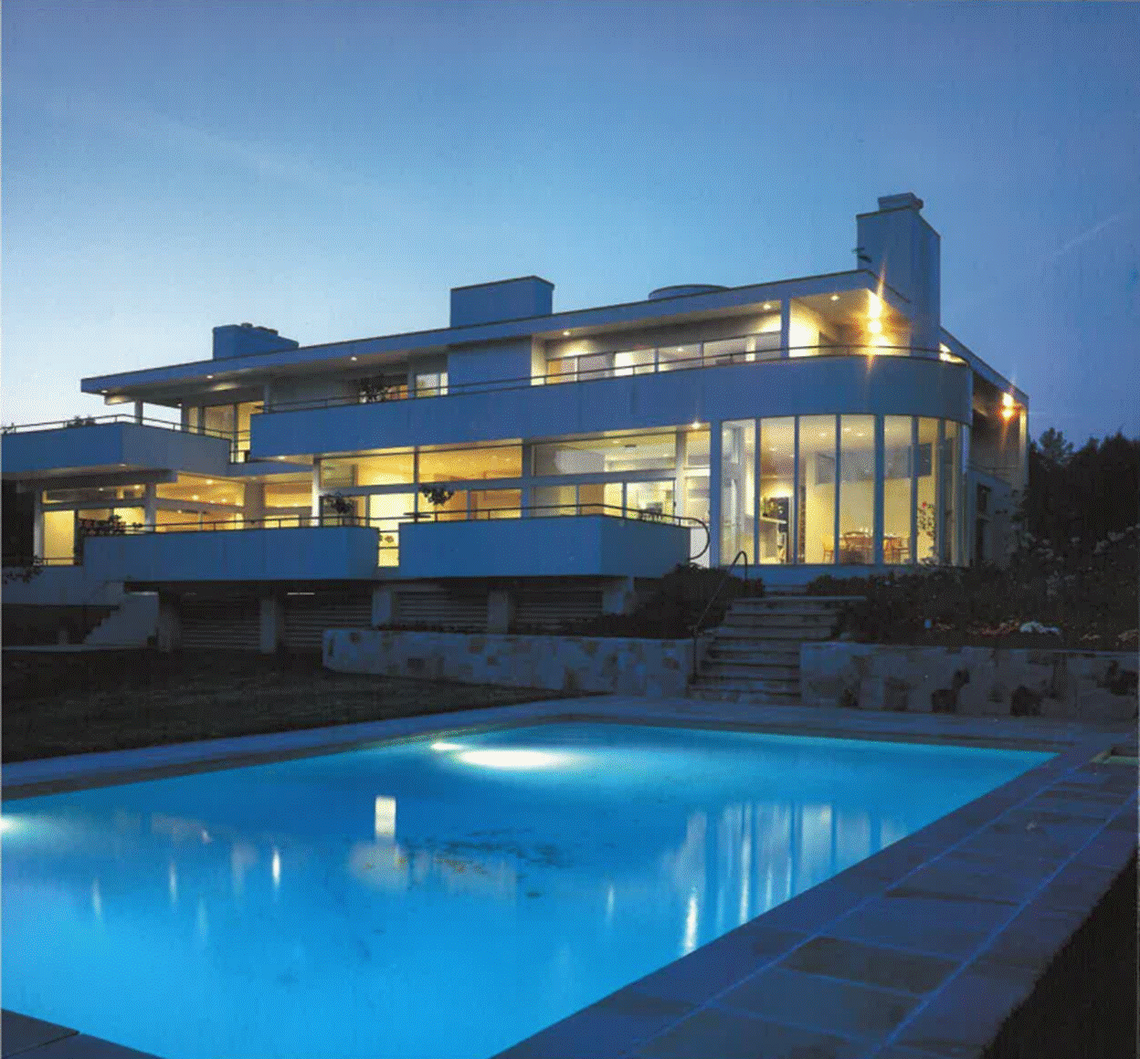 A pool in front of a house
