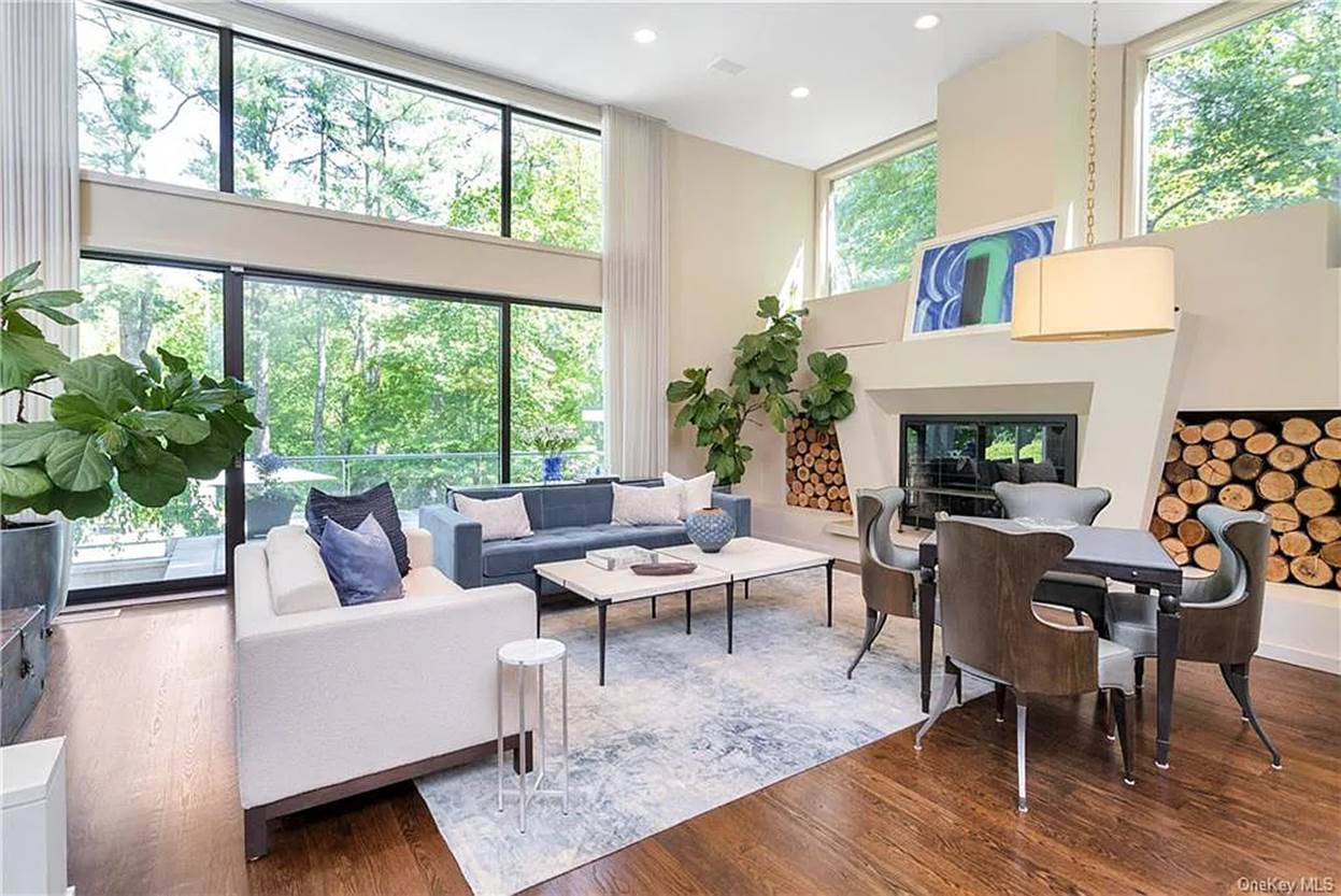 A living room with a fireplace and a dining table
