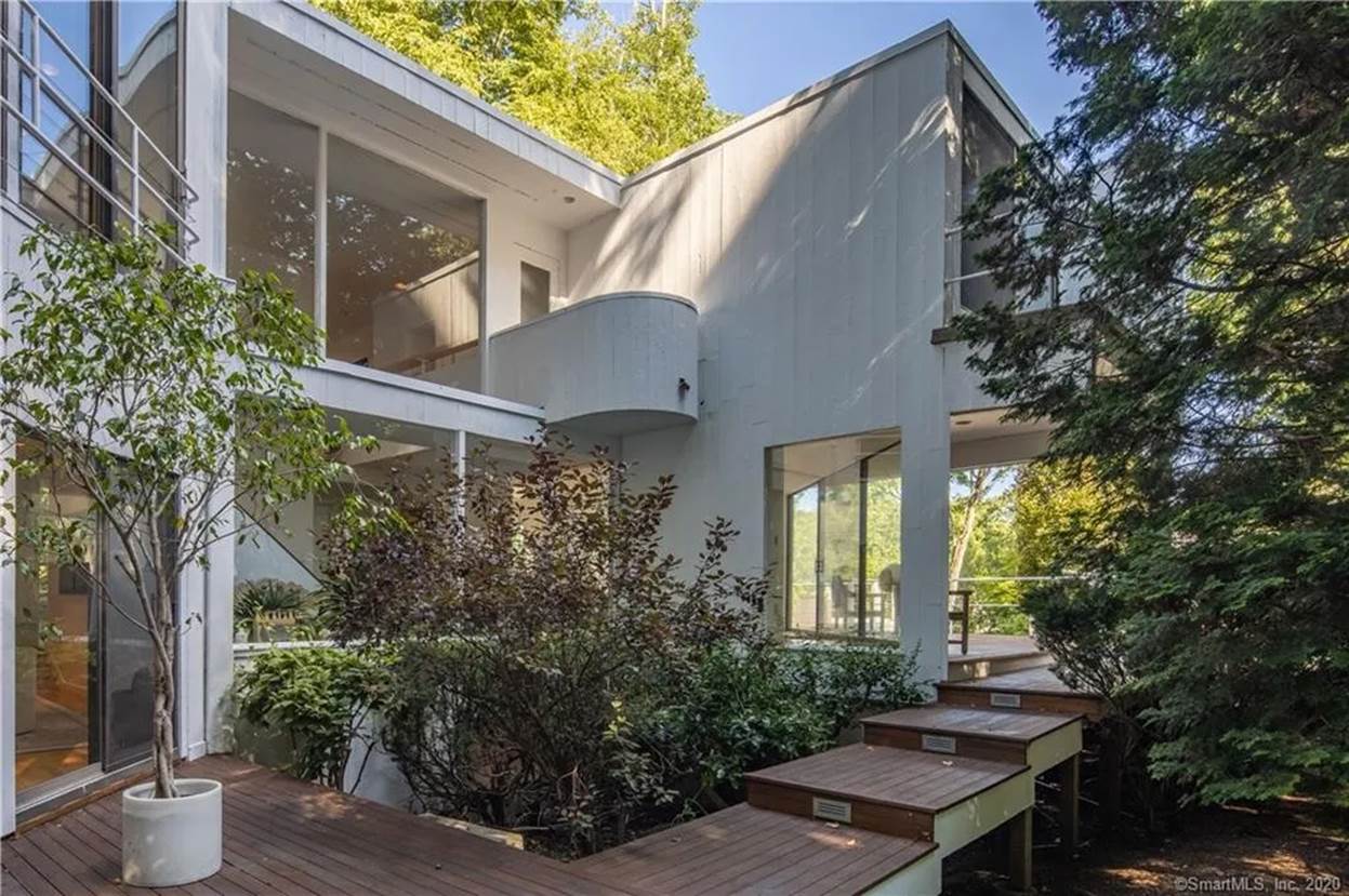 A house with a deck and trees
