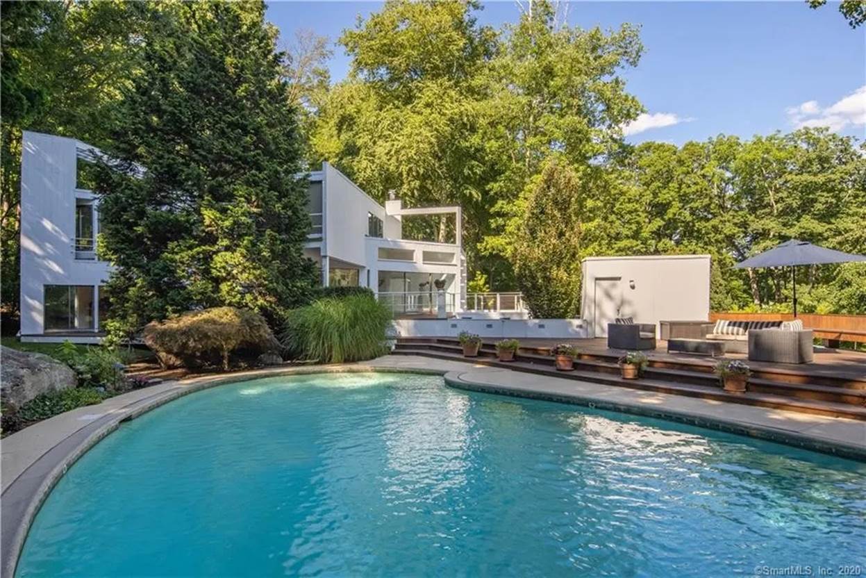 A swimming pool with trees around it
