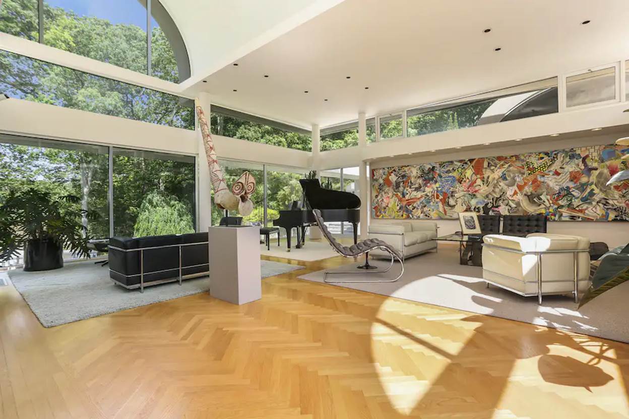 A room with a piano and art on the wall
