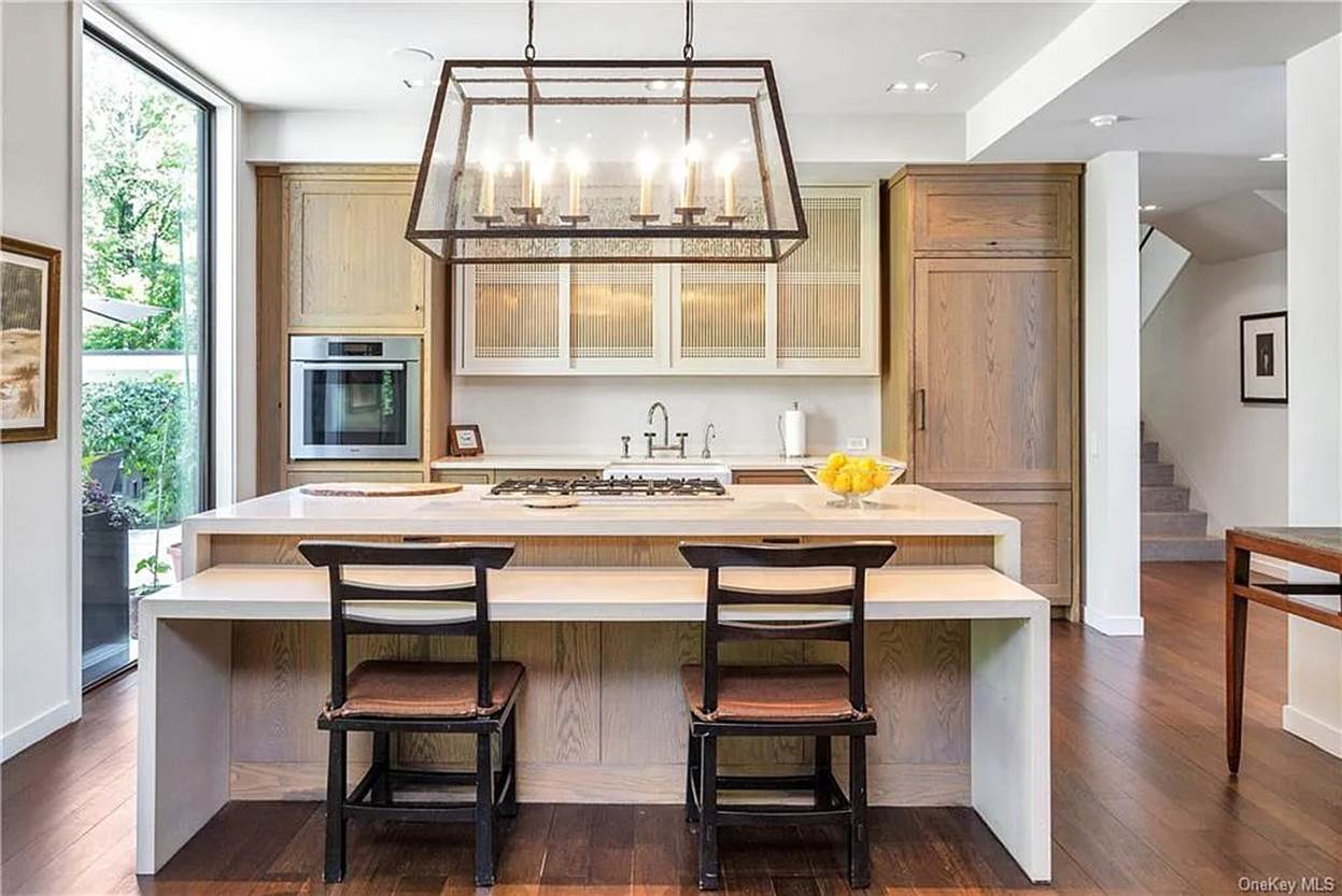 A kitchen with a island and a chandelier
